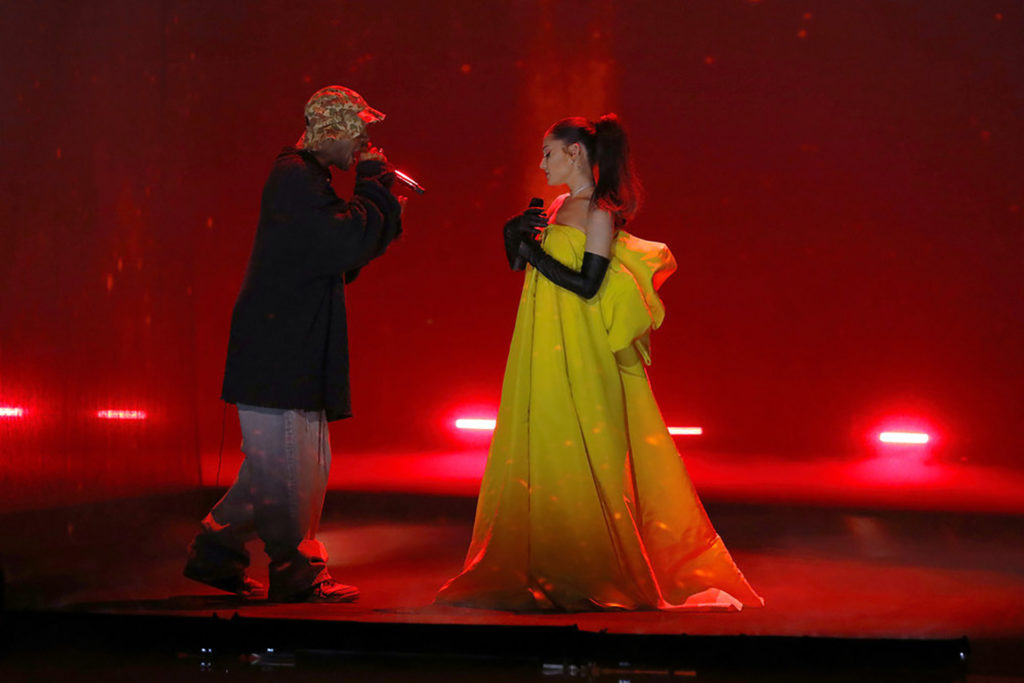 During last night's finale of The Voice, Ariana Grande stunned on stage in a Canary yellow gown while performing new track, "Just Look Up" alongside "Day 'n' Nite" rapper Kid Cudi. The new song is featured in Netflix's star-studded film, Don't Look Up.