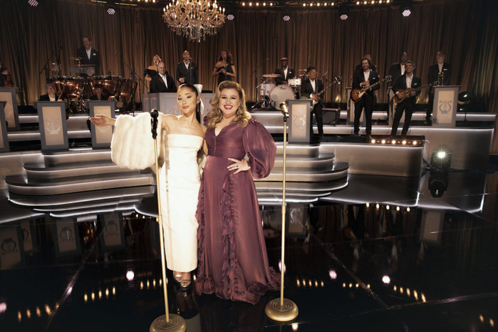 In last night's Kelly Clarkson Presents: When Christmas Comes Around holiday special, Ariana Grande stunned in a sultry ivory-colored Hollywood ensemble. The 28-year-old powerhouse singer wowed the audience as she performed "Santa, Can't You Hear Me" alongside Clarkson.
