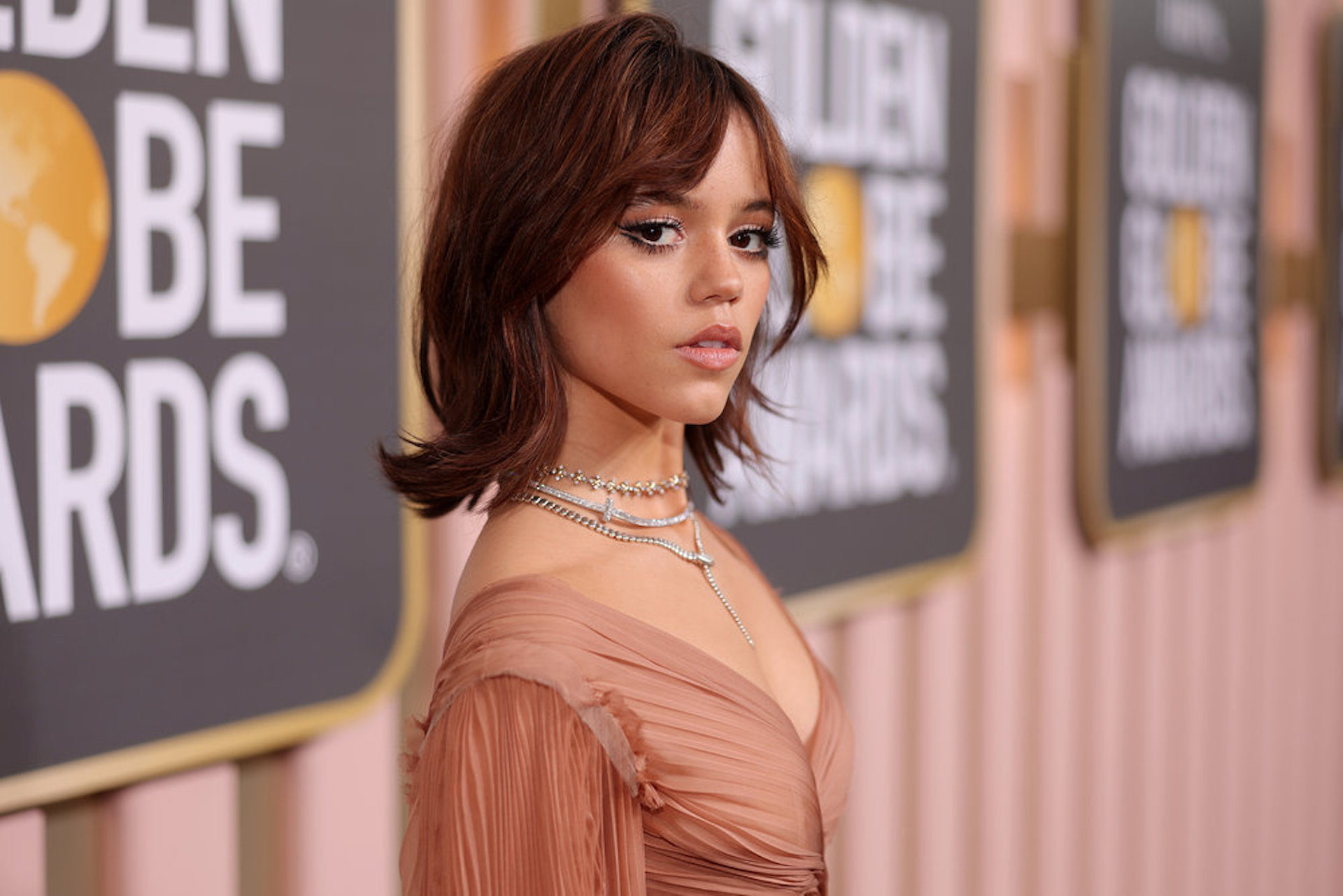 Starring in the Netflix hit series, Jenna Ortega says she is stunned by 'Wednesday's success at the Golden Globe Awards (and she looks stunning doing it).