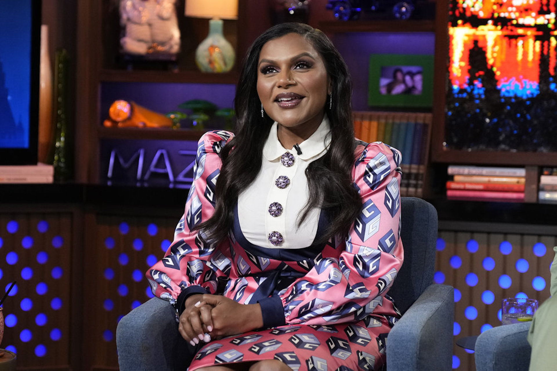 Mindy Kaling flashes her bra on a break from filming The Mindy Project