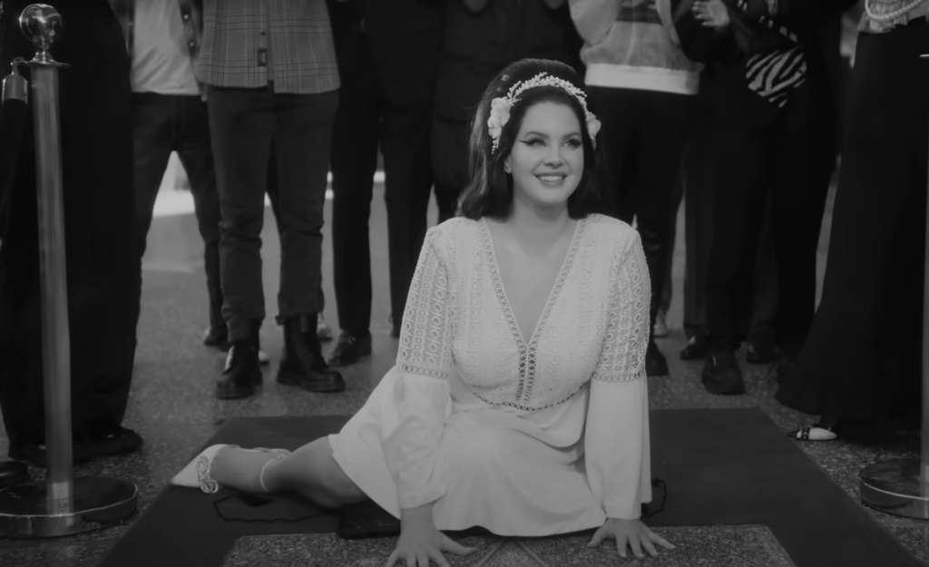 Lana Del Rey channels old Hollywood glamour in her haunting new music video for “Candy Necklace” featuring Grammy-winning artist, Jon Batiste.