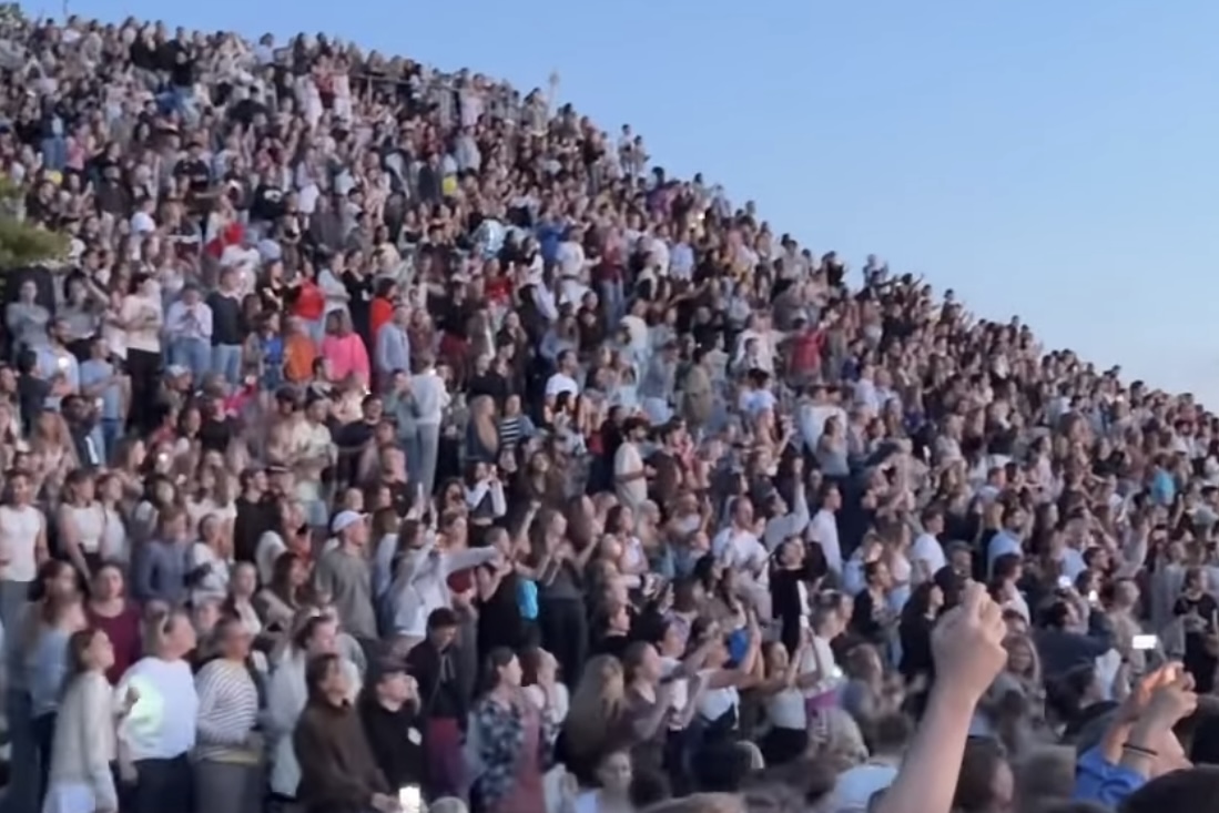 Thousands of Eras Tour fans spread across a local hill near the concert venue to watch Taylor Swift in Munich, Germany.