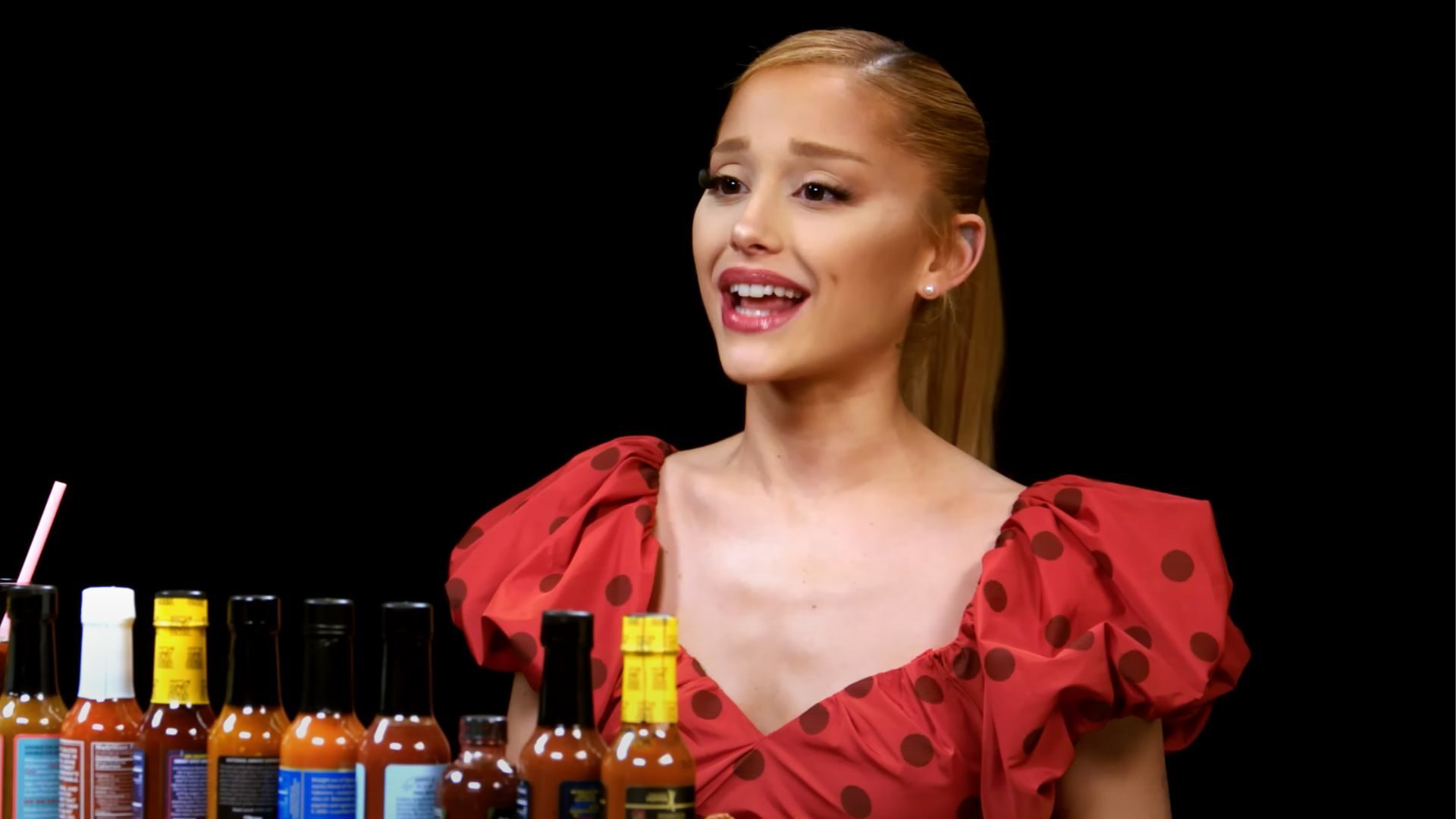 Ariana Grande confronts a spicy challenge on the latest episode of 'Hot Ones' while discussing 'Wicked,' music leaks, and emotional songs.