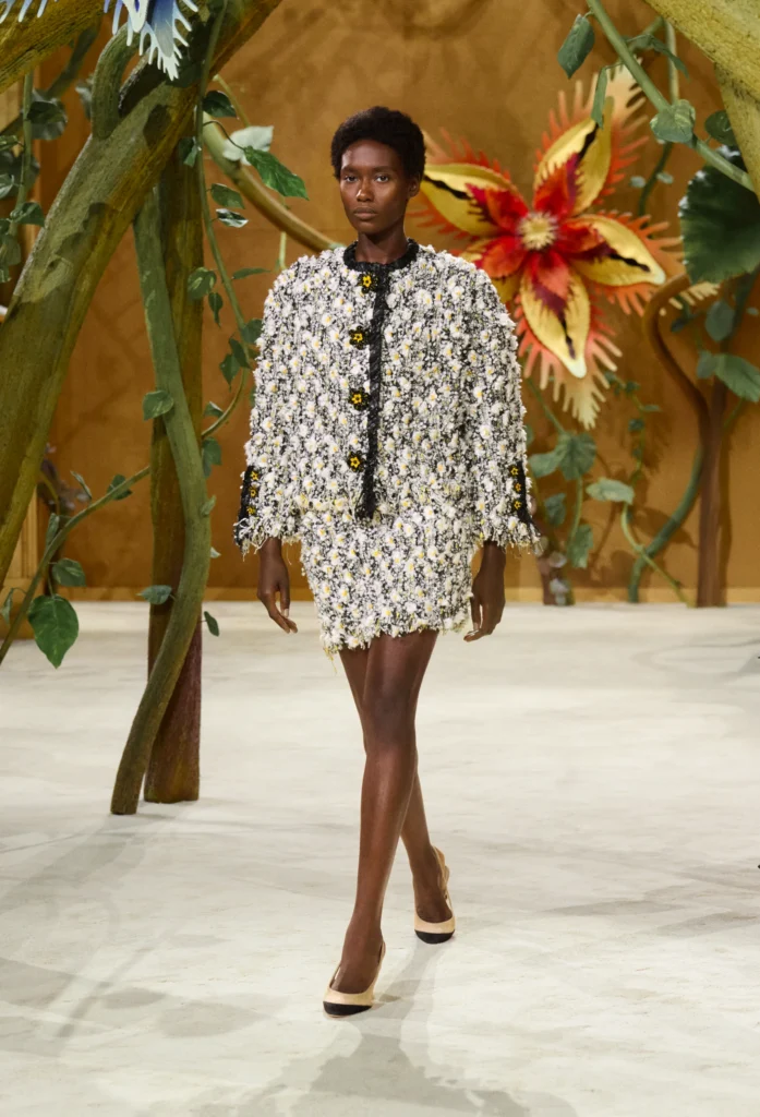 On the second day of Paris Haute Couture Week, creative director Matthieu Blazy unveiled his second couture collection for the House, and darling, he did not come to play it safe. Titled "Gaby and the Beanstalk," the Fall/Winter 2026-2027 collection was born from a book of fairytales — Les Fées, Contes des Contes — that Blazy discovered tucked away in Gabrielle Chanel's personal library. From that single spark, he built an entire enchanted world inside the Grand Palais.