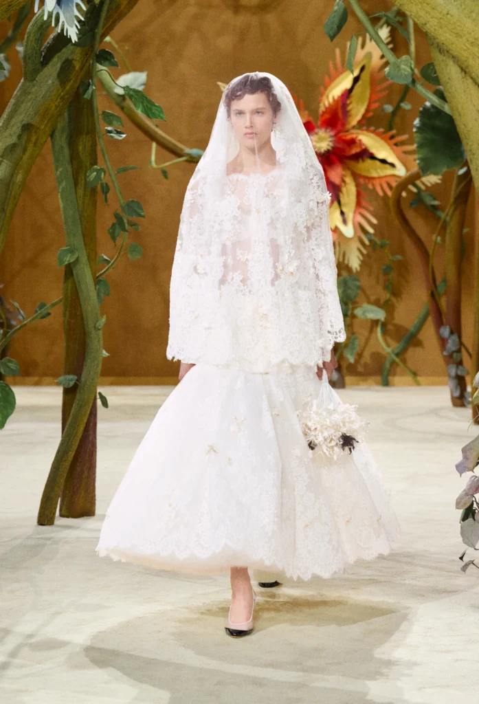 On the second day of Paris Haute Couture Week, creative director Matthieu Blazy unveiled his second couture collection for the House, and darling, he did not come to play it safe. Titled "Gaby and the Beanstalk," the Fall/Winter 2026-2027 collection was born from a book of fairytales — Les Fées, Contes des Contes — that Blazy discovered tucked away in Gabrielle Chanel's personal library. From that single spark, he built an entire enchanted world inside the Grand Palais.