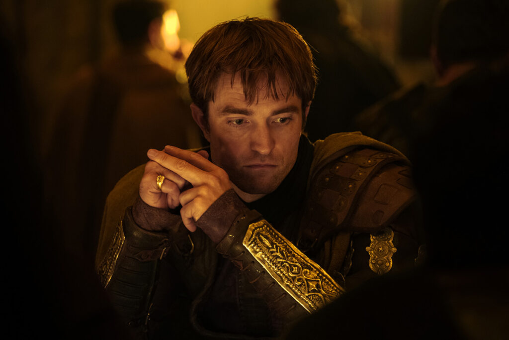 Let me say the quiet part loudly: Christopher Nolan did not make a swords-and-sandals adventure. He made a war film wearing a myth as a mask, and it may be the most punishing, beautiful thing he has ever put on a screen. The Odyssey is his thirteenth feature, the first narrative film in history shot entirely on IMAX film, and already the biggest global launch of his career — an instant awards frontrunner that had the industry roaring from its first CinemaCon footage onward, in a year that suddenly has very little competition. Coming off Oppenheimer, Nolan has essentially made a companion piece in bronze: another story about a brilliant man whose single clever idea unleashes a horror the world cannot put back in the box. If Oppenheimer gave us the father of the atomic bomb, The Odyssey gives us his Bronze Age ancestor.