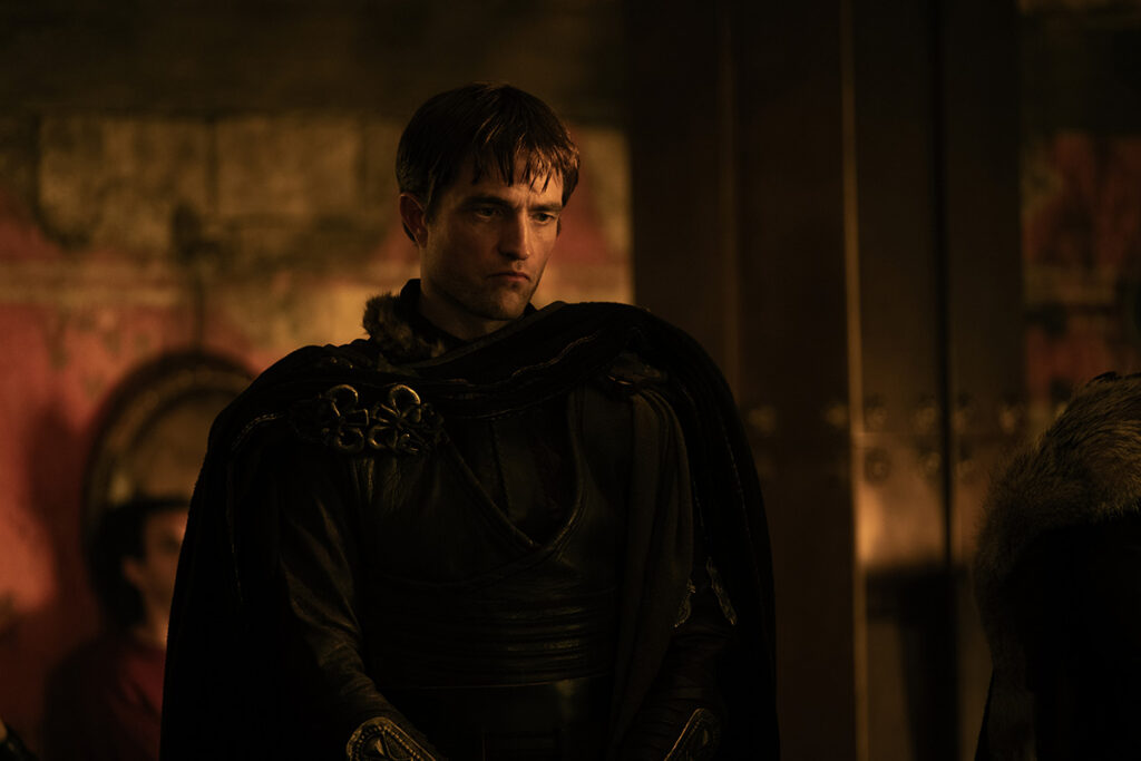 Let me say the quiet part loudly: Christopher Nolan did not make a swords-and-sandals adventure. He made a war film wearing a myth as a mask, and it may be the most punishing, beautiful thing he has ever put on a screen. The Odyssey is his thirteenth feature, the first narrative film in history shot entirely on IMAX film, and already the biggest global launch of his career — an instant awards frontrunner that had the industry roaring from its first CinemaCon footage onward, in a year that suddenly has very little competition. Coming off Oppenheimer, Nolan has essentially made a companion piece in bronze: another story about a brilliant man whose single clever idea unleashes a horror the world cannot put back in the box. If Oppenheimer gave us the father of the atomic bomb, The Odyssey gives us his Bronze Age ancestor.