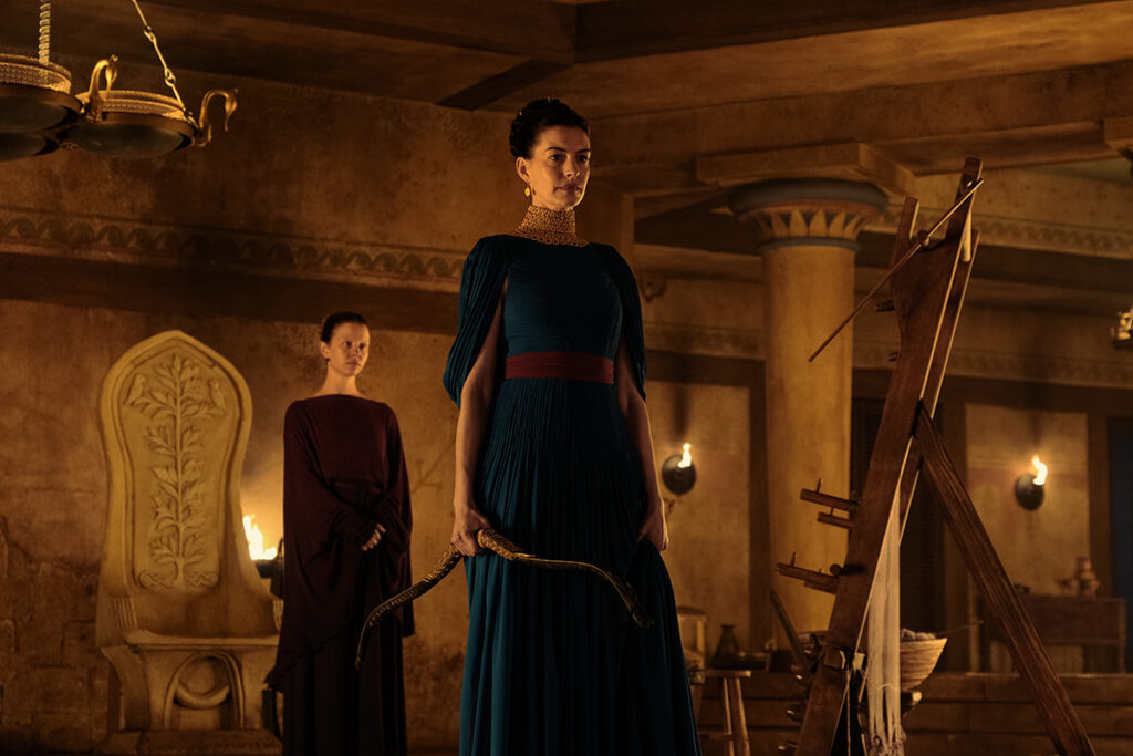 Let me say the quiet part loudly: Christopher Nolan did not make a swords-and-sandals adventure. He made a war film wearing a myth as a mask, and it may be the most punishing, beautiful thing he has ever put on a screen. The Odyssey is his thirteenth feature, the first narrative film in history shot entirely on IMAX film, and already the biggest global launch of his career — an instant awards frontrunner that had the industry roaring from its first CinemaCon footage onward, in a year that suddenly has very little competition. Coming off Oppenheimer, Nolan has essentially made a companion piece in bronze: another story about a brilliant man whose single clever idea unleashes a horror the world cannot put back in the box. If Oppenheimer gave us the father of the atomic bomb, The Odyssey gives us his Bronze Age ancestor.